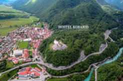 Panoramic aerial vista revealing Premium Hostel Kobarid's scenic spot amidst the enchanting Soca Valley